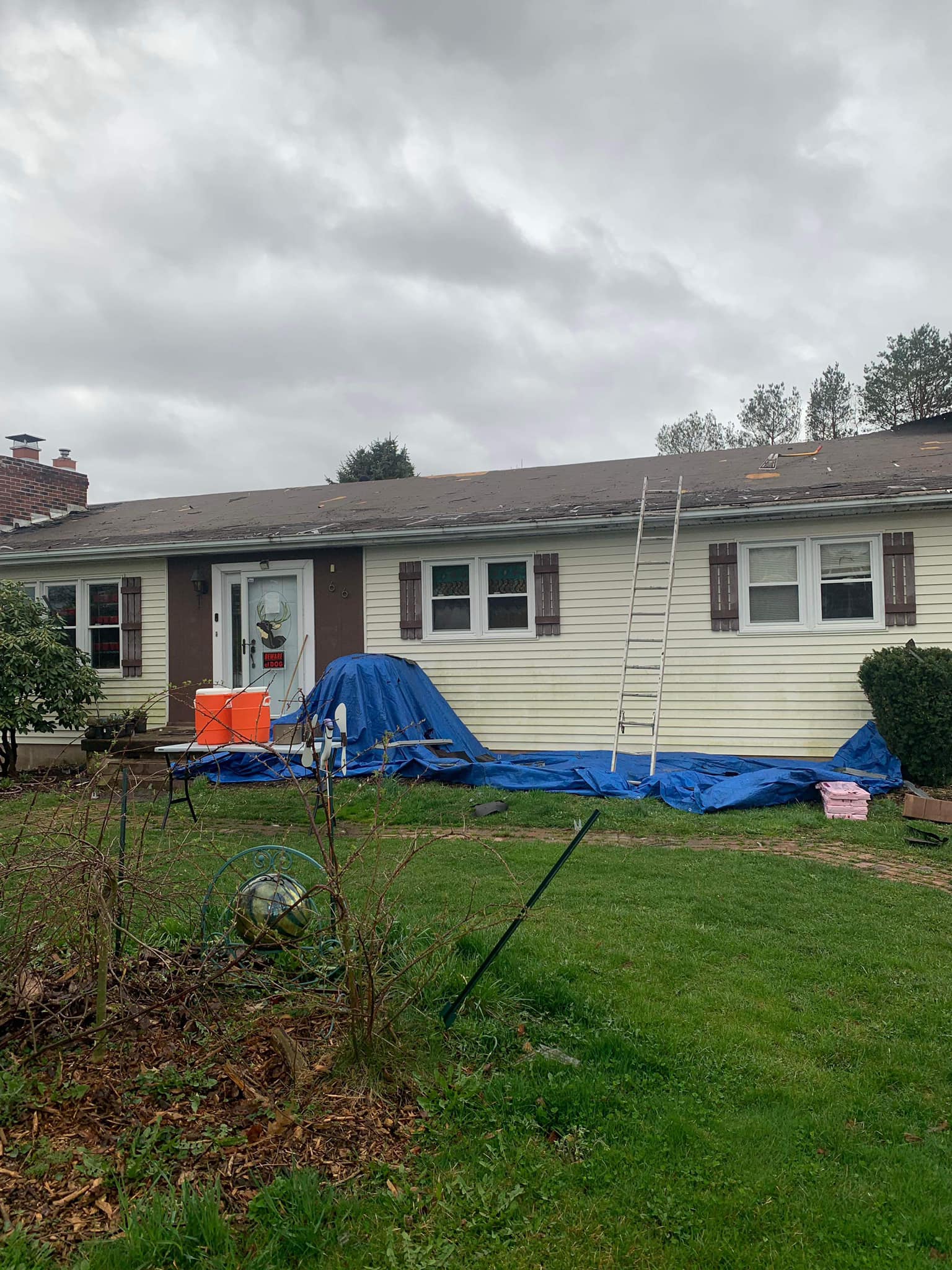 Complete roof replacement project showing tear-off process and residential roofing installation