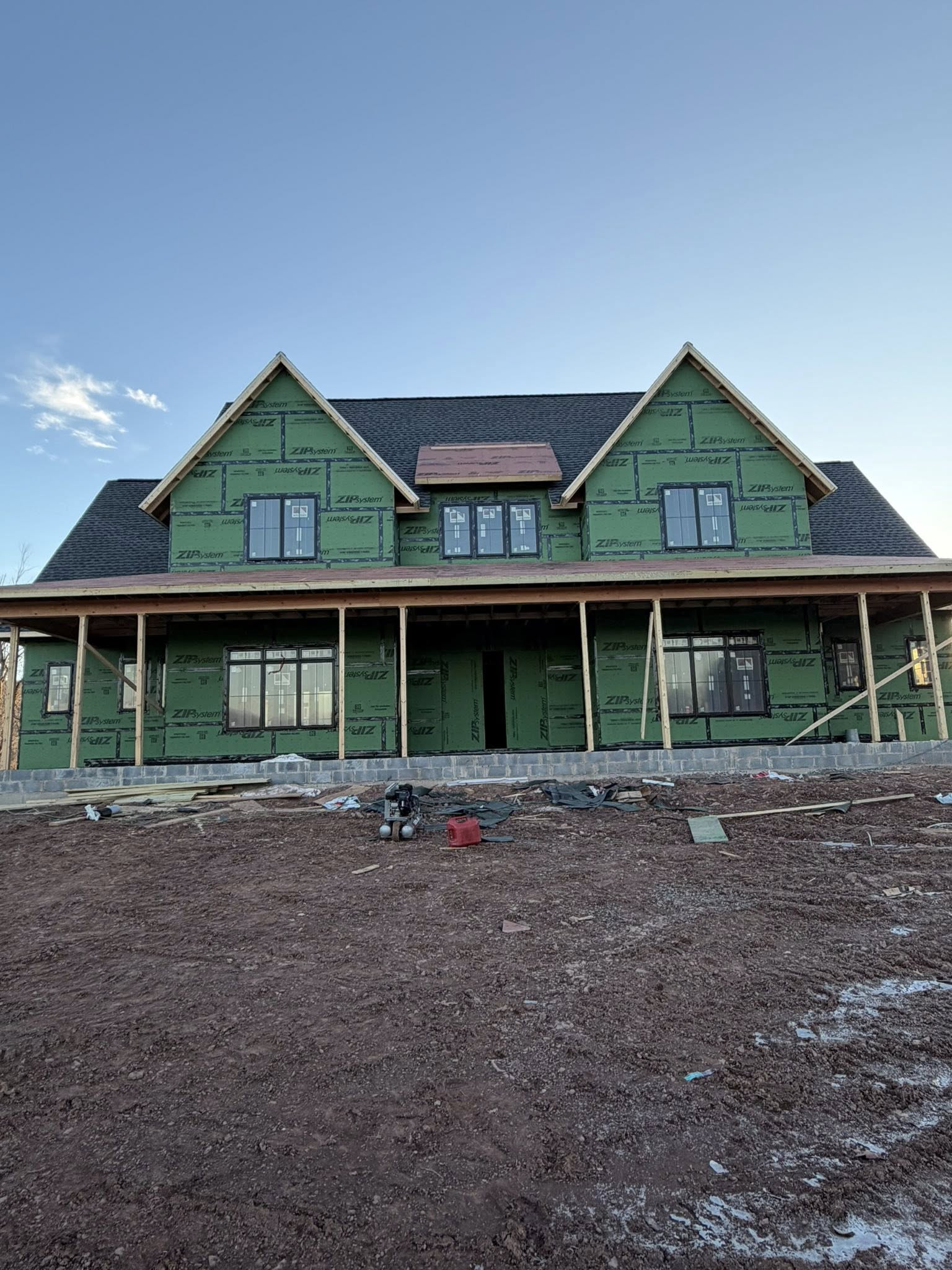 New construction residential roof installation with architectural shingles on custom-built home